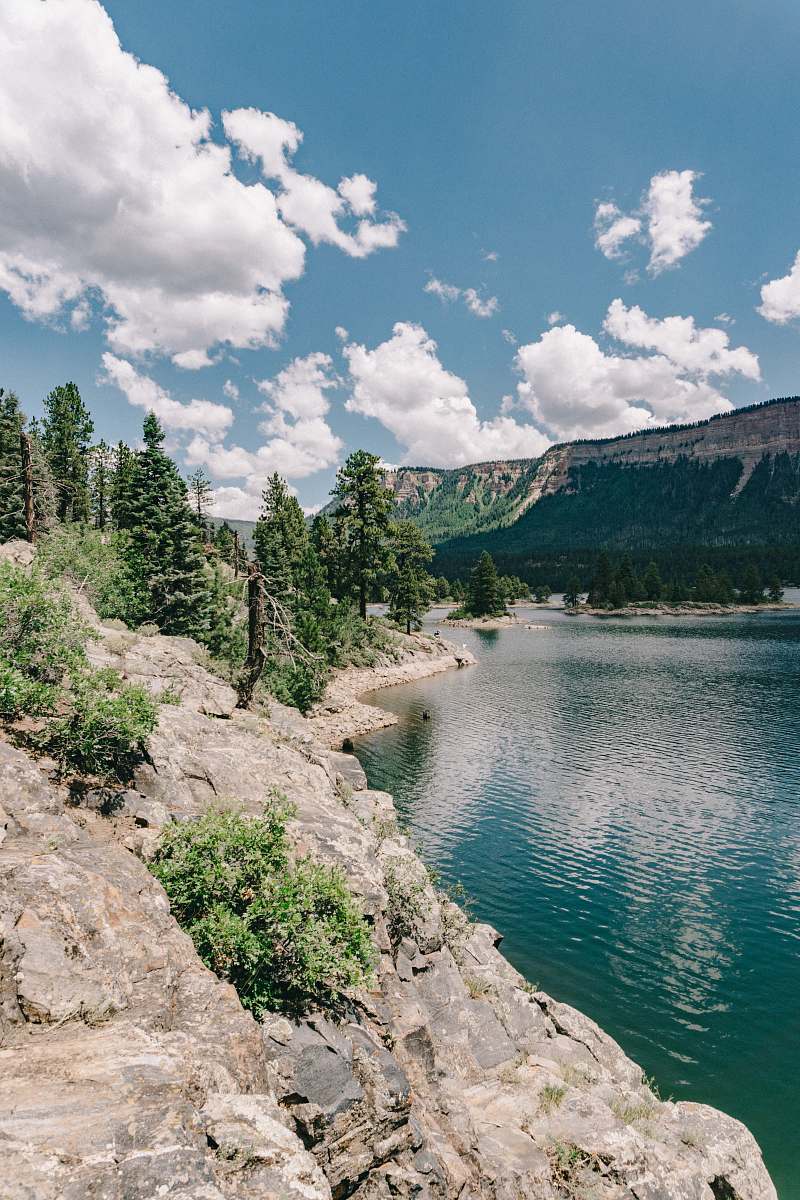 electra lake green trees and mountain by the water under blue sky and white clouds during daytime landscape